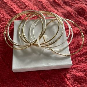 New In Box. Set of  9 Bangle Bracelets - Gold tone and Silver tone.